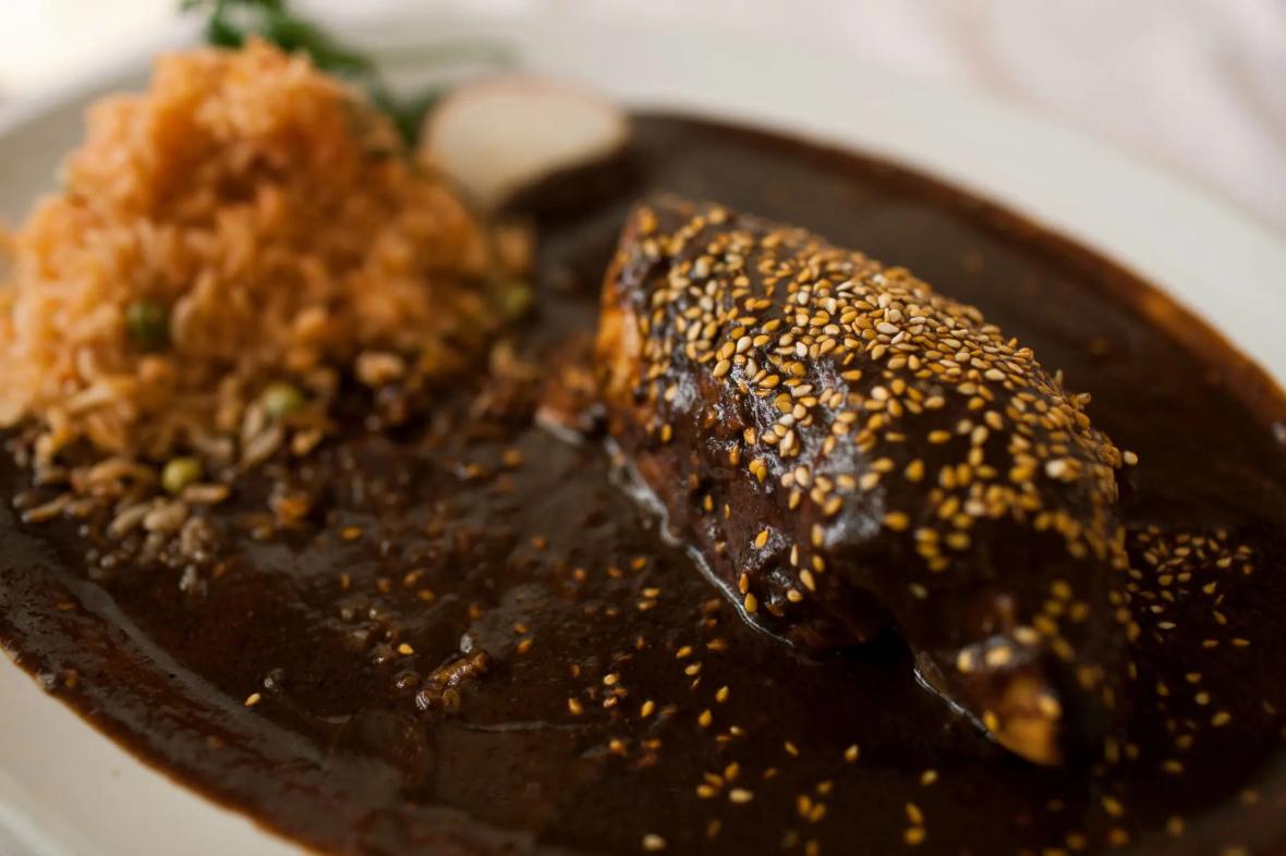 Chicken with mole poblano, a sauce made with chocolate, nuts, chiles and spices, at a restaurant in Puebla, Mexico Chicken with mole poblano, a sauce made with chocolate, nuts, chiles and spices, at a restaurant in Puebla, Mexico